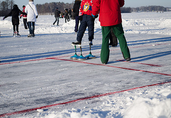 Image showing eisstock curling toys and people play winter game 