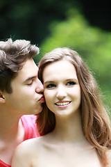 Image showing Young man kissing his girlfriend