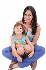 Image showing mother and daughter sitting on the floor and hugging each other 