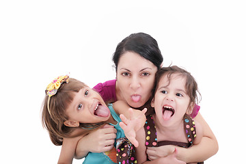 Image showing Mother and two daughter pulling funny faces at camera