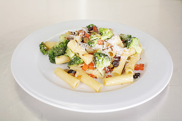 Image showing Rigatoni with vegetables served on a white plate. 