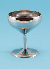 Image showing retro grunge wine glass goblet on blue background 