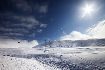 Image showing Ski slope, gondola lift and blue sky with sun