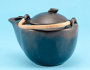 Image showing black retro teapot blue background 