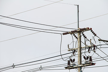 Image showing Concrete pole with power lines and insulators.