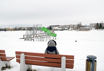 Image showing woman sit bench water cascade playground winter 