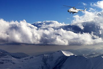 Image showing Helicopter in winter mountains