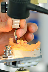 Image showing Dental technician measuring dentures