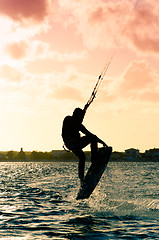 Image showing Silhouette of a kitesurfer flying