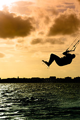 Image showing Silhouette of a kitesurfer flying