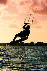 Image showing Silhouette of a kitesurfer flying