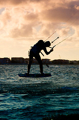 Image showing Silhouette of a kitesurfer flying