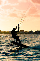 Image showing Silhouette of a kitesurfer flying