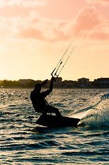 Image showing Silhouette of a kitesurfer flying