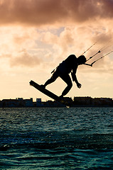 Image showing Silhouette of a kitesurfer flying