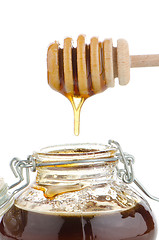 Image showing Jar of honey with wooden drizzler