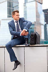 Image showing Businessman near office towers