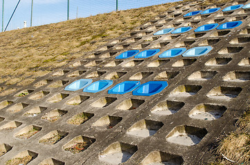 Image showing cement slope surface mounted blue chairs rest 