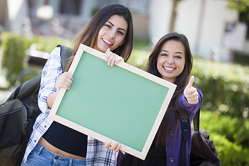 Image showing Mixed Race Female Students with Thumbs Up Holding Blank Chalkboa