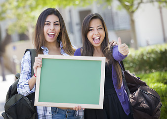 Image showing Mixed Race Female Students with Thumbs Up Holding Blank Chalkboa