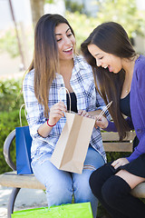 Image showing Young Adult Mixed Race Women Looking Into Their Shopping Bags