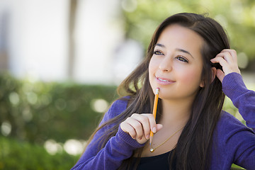 Image showing Pensive Mixed Race Female Student with Pencil on Campus