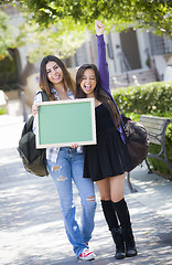 Image showing Excited Mixed Race Female Students Holding Blank Chalkboard