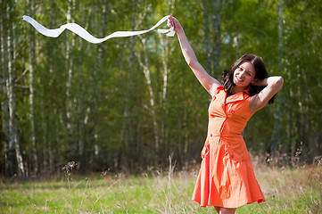 Image showing Pretty girl playing with tape