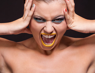 Image showing attractive young woman scream out loud with yellow lipstick