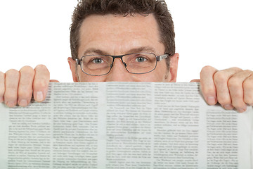 Image showing attractive adult businessman reading newspaper isolated