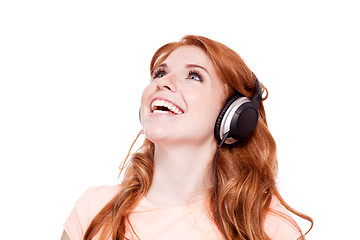 Image showing attractive happy woman with headphones listen to music isolated