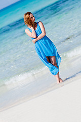 Image showing beautiful woman in blue dress on beach in summer
