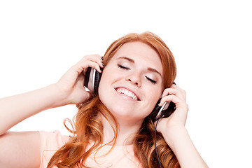 Image showing attractive happy woman with headphones listen to music isolated