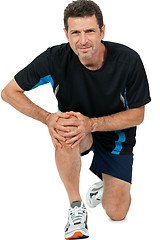 Image showing adult attractive man in sportswear knee pain injury ache isolated