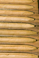 Image showing hand made cigars in press storage