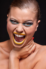 Image showing attractive young woman scream out loud with yellow lipstick
