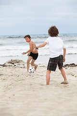 Image showing happy family father two kids playing football on beach summer 