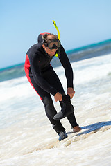 Image showing male diver with diving suit snorkel mask fins on the beach