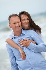 Image showing happy adult couple in summertime on beach 