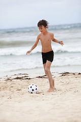 Image showing happy family father two kids playing football on beach summer 