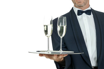 Image showing adult male waiter serving two glass of champagne isolated