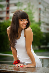 Image showing Pretty smiling girl with red beads