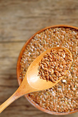 Image showing close up of flax seeds and wooden spoon 