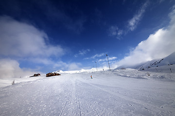 Image showing Snowboarder on piste slope in nice day