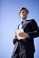 Image showing Businessman holding tablet