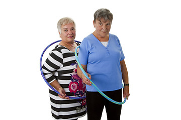 Image showing Senior lady doing gymnastic with hula hoop