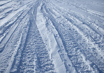 Image showing Car tracks crossing the snowy terrain