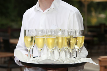 Image showing Waiter with a tray of champagne flutes