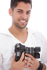 Image showing Smiling man with a digital camera