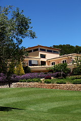 Image showing Manicured lawns below a clubhouse